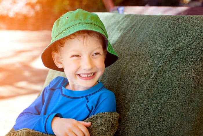 Child drying off in the shade during summer.