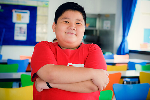 Male patient with arms folded, smiling
