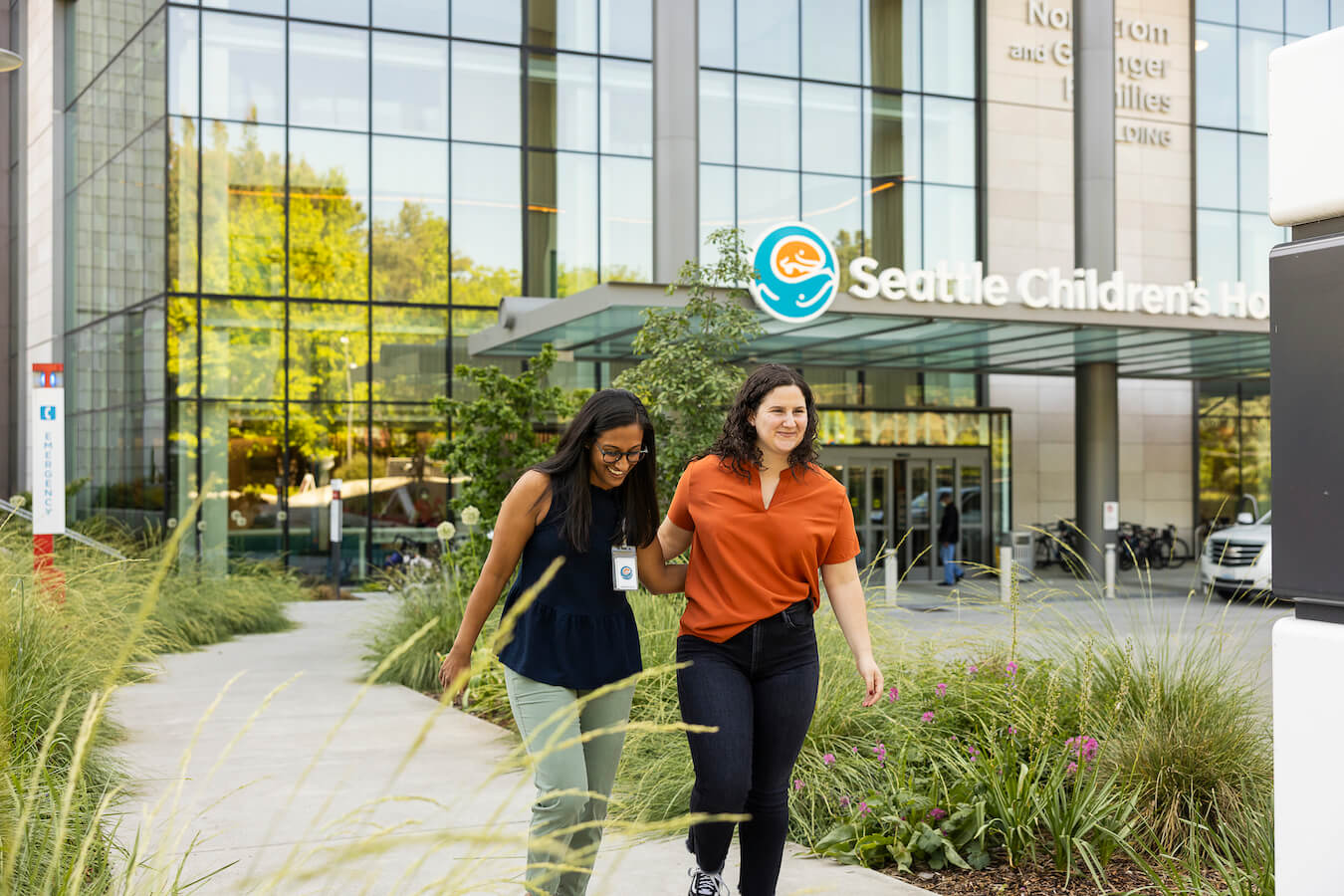 Patient and provider laughing while walking side by side