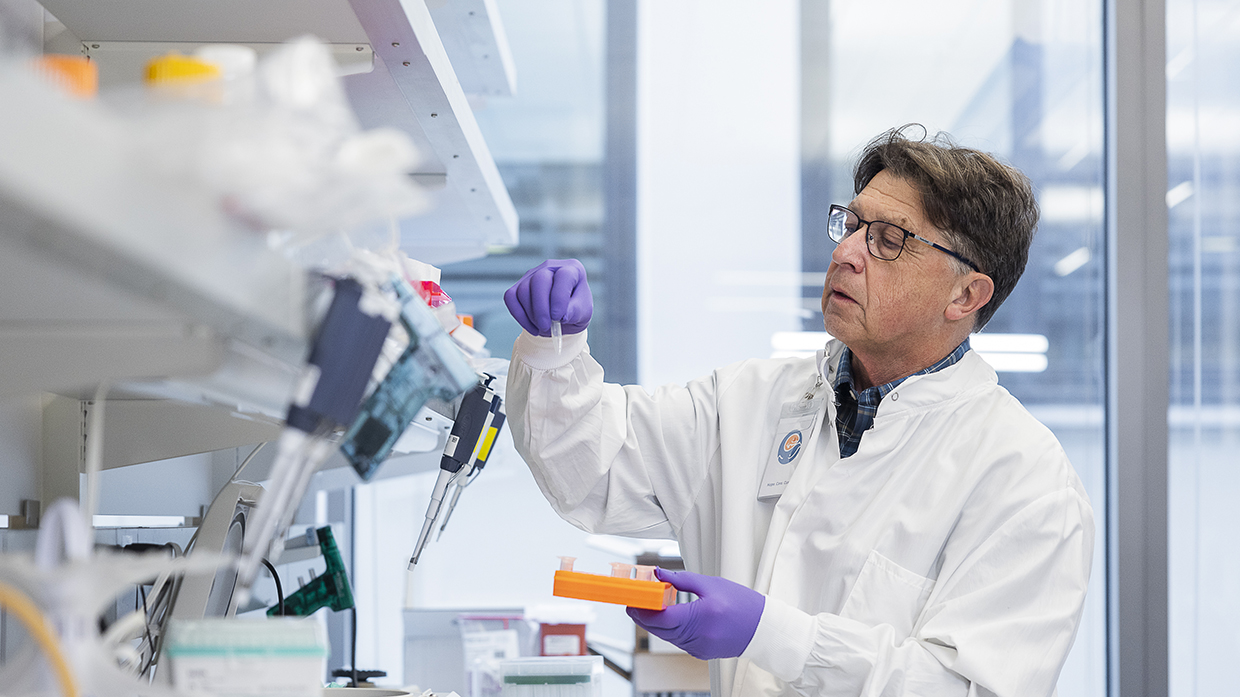 Researcher Dr. Bruce Torbett examining a sample in the lab