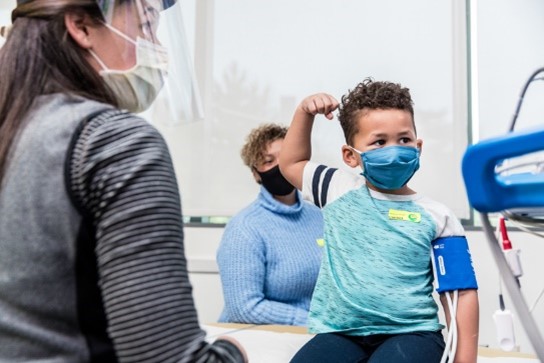 A boy flexes his bicep at Seattle Children's