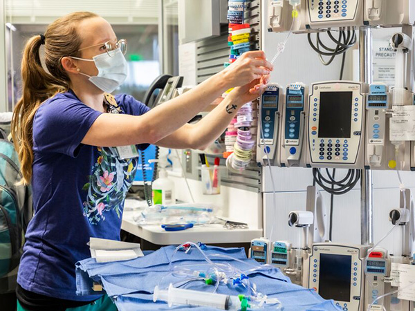 A nurse prepares medical equipment