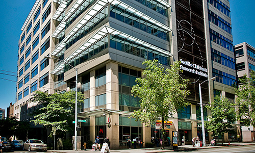 An exterior view of a large building in the Seattle with signage that reads, "Seattle Children's Research Institute"
