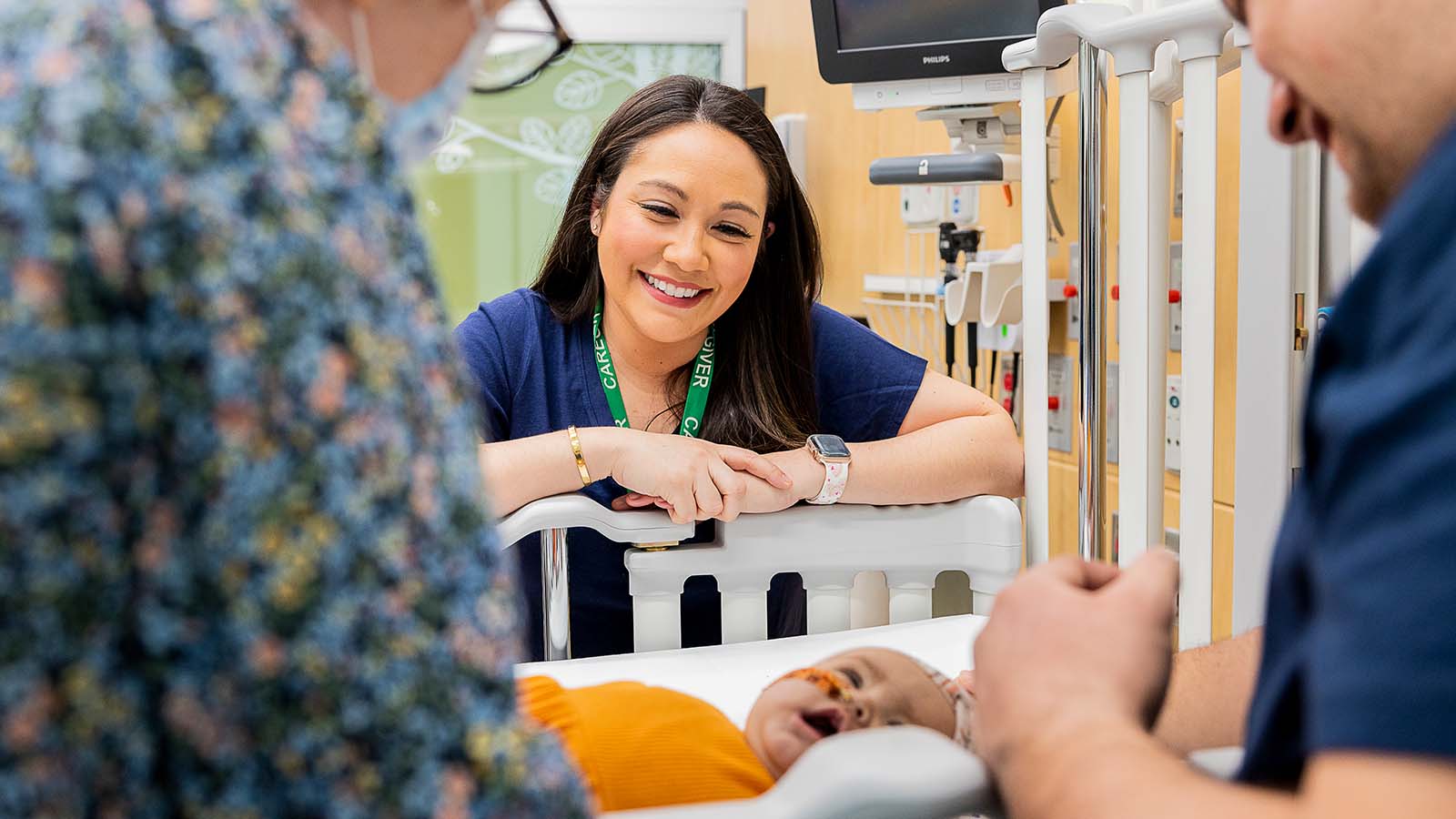 Nurse looks at an infant.