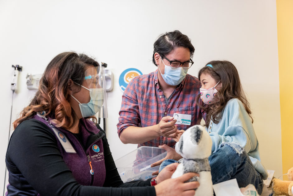 A father and daughter meet with a doctor