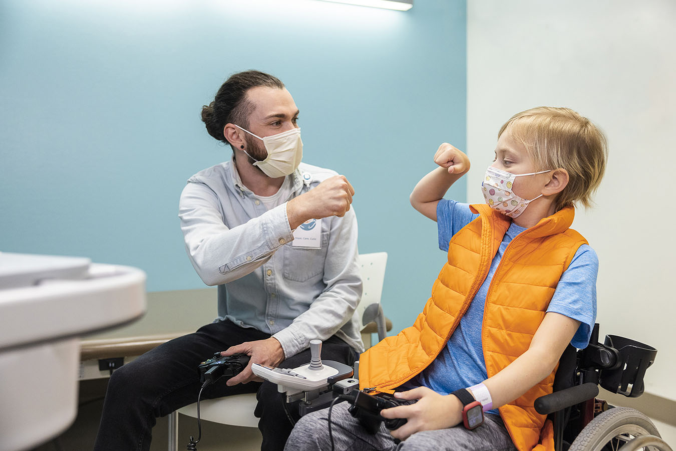 Forest Coyle and patient fist bump each other