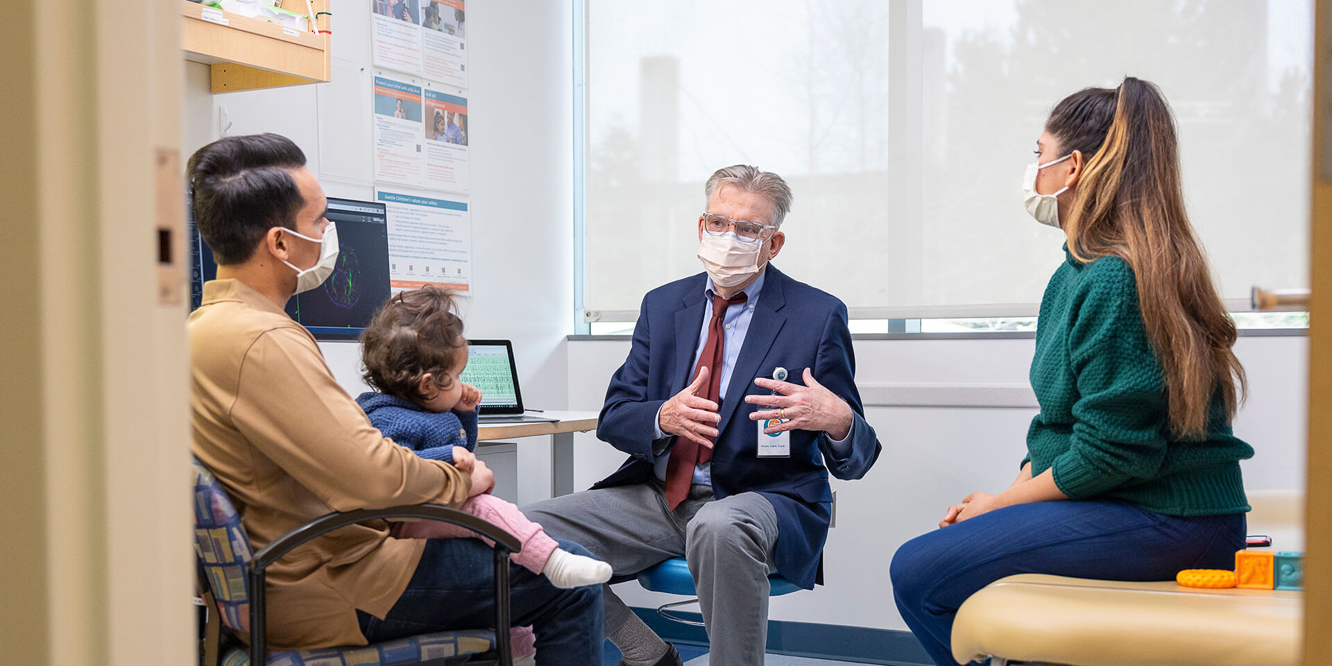 Patient, parents and provider in a clinical room