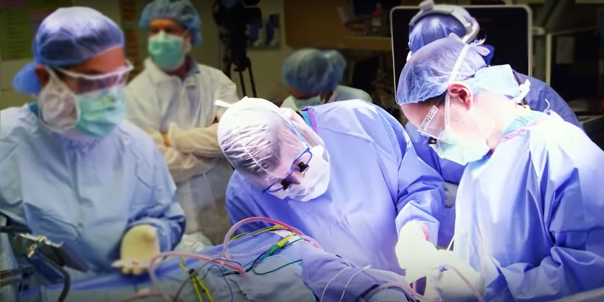 Surgeons looking down at a patient