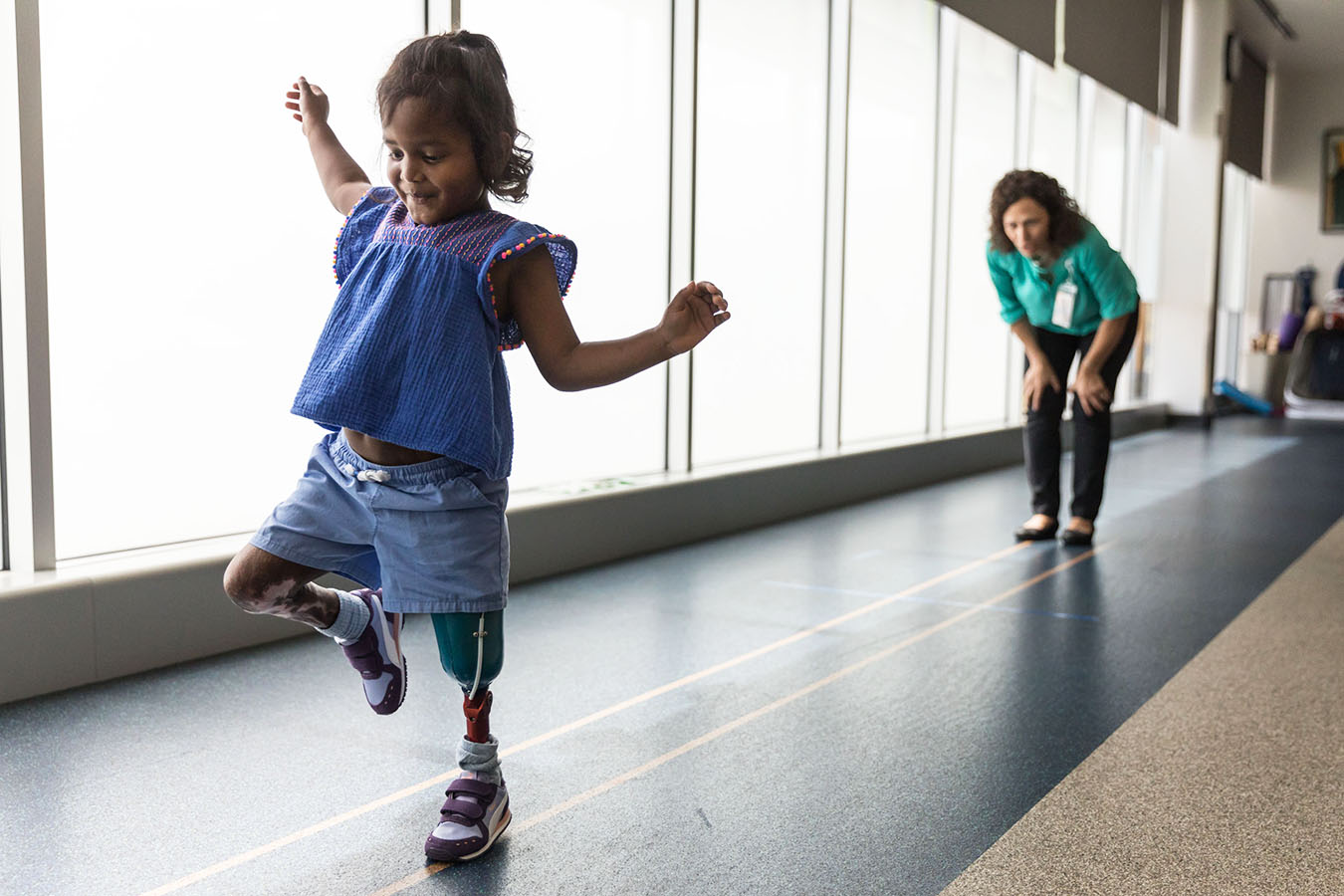 A patient skips ahead of a provider using a prosthetic