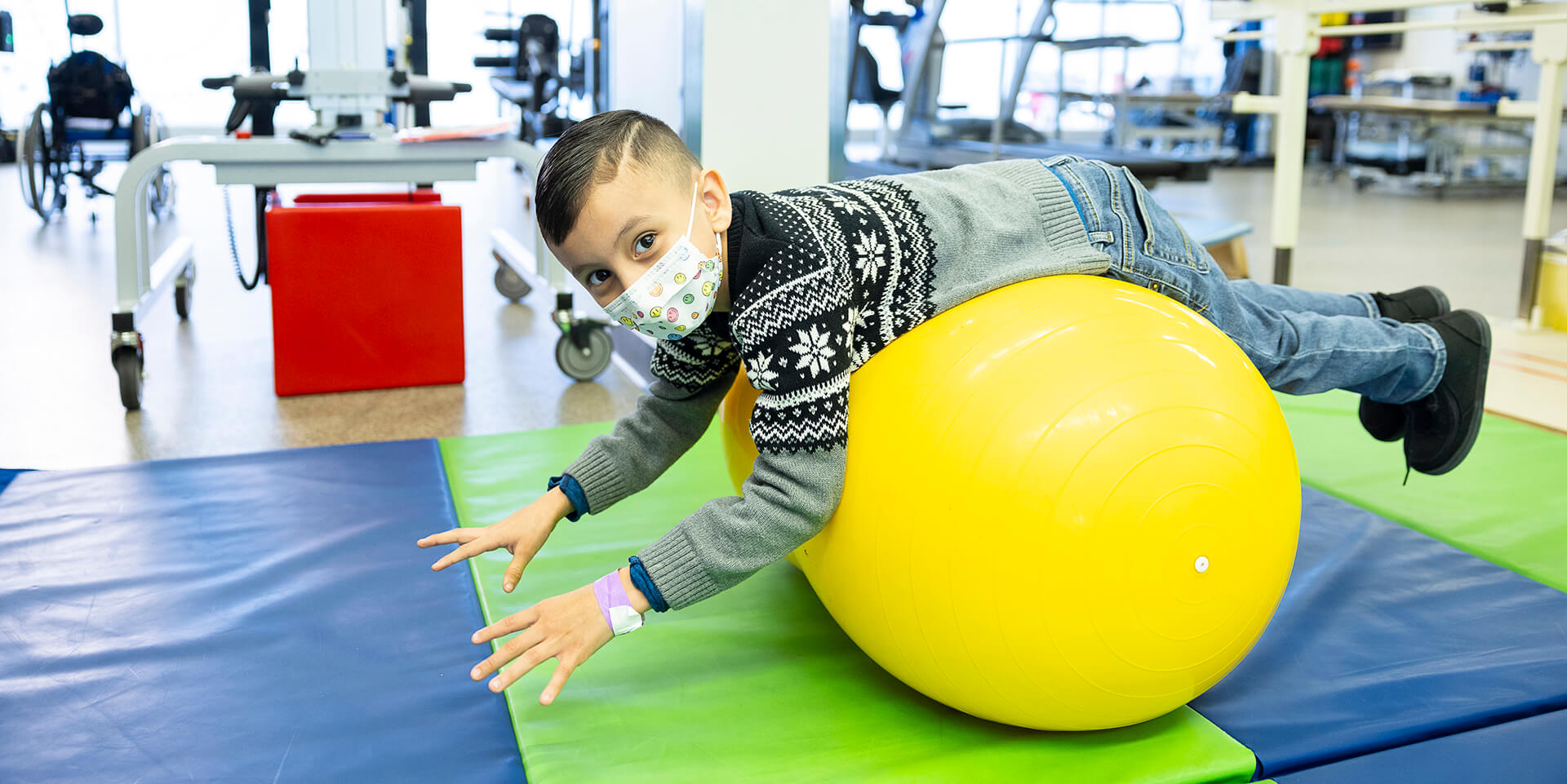 A child balances on an exercise ball