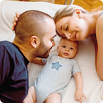 dad, baby and mom on the floor