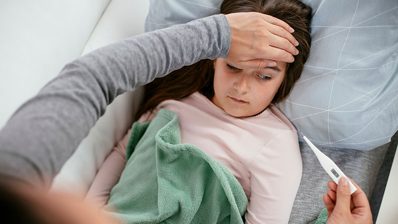 A mother checks her daughters temperature