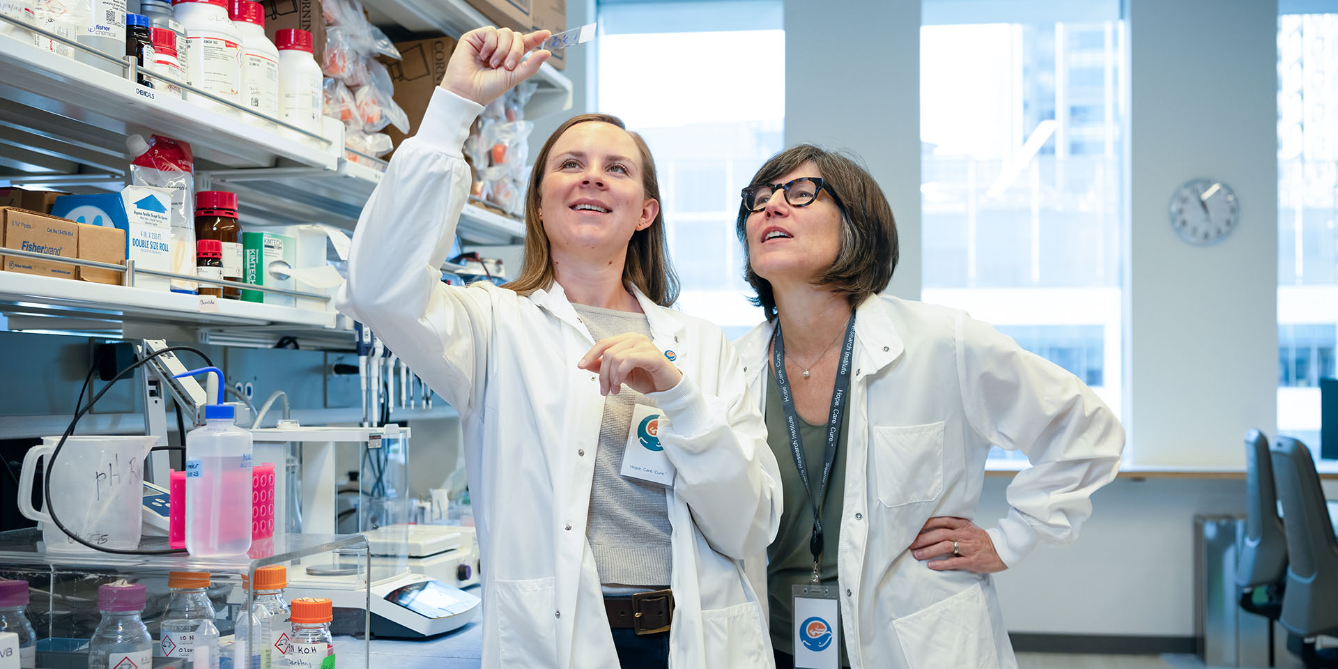Researchers at Lawlor Lab examine a slide