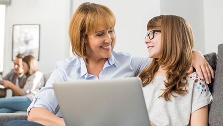 woman and girl at laptop