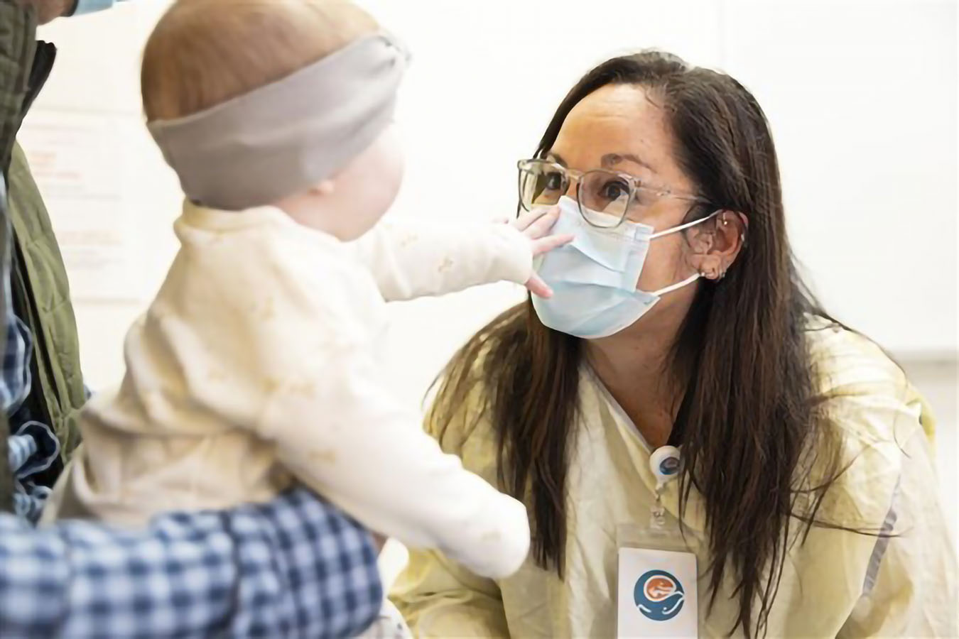 A doctor reacts to an infant patient