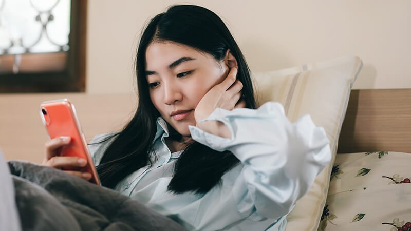 A woman looks at a phone