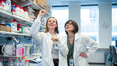 Affiliate Invent scholar Dr. Emma Wrenn shows a slide to mentor Dr. Beth Lawlor 