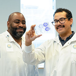 Invent at Seattle Children’s mentor Dr. Myron Evans looks at a lab sample with scholar Dr. Stephen Carney 