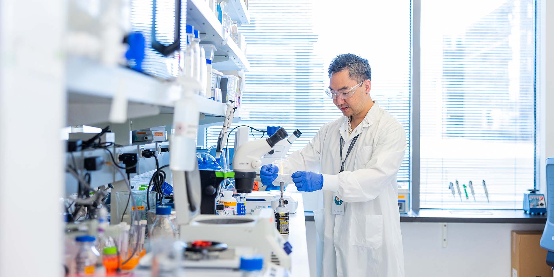 A researcher in a lab inspects a sample