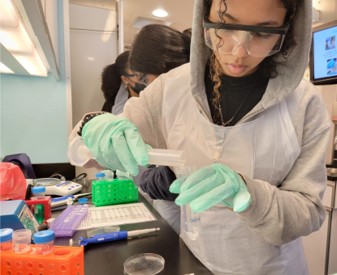 Student using a graduated cylinder to prepare a stock solution of Vitamin C